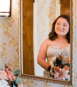 Bride in dress looking into mirror