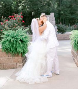 Groom and bride kissing.