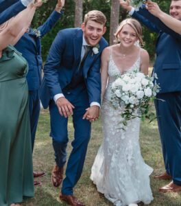 Wedding couple going through human tunnel