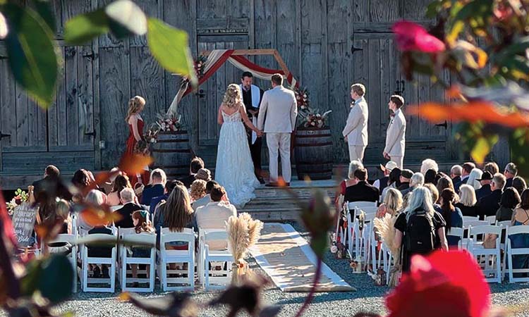 Wedding in front of barn wall